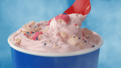 A Cup Of Ice Cream With A Red Spoon In It GIF
