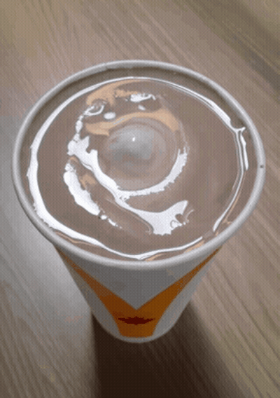 A Cup Of Milkshake With A Swirl On Top GIF