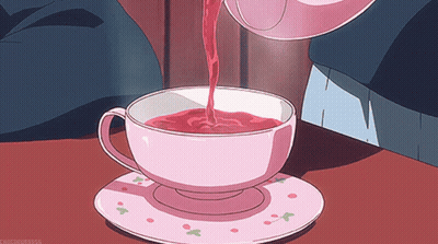 A Cup Of Tea Is Being Poured From A Teapot Into A Cup GIF