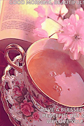 A Cup Of Tea Is On A Saucer Next To A Book GIF