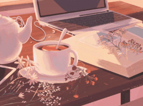 A Cup Of Tea Sits On A Table Next To A Book And A Laptop GIF