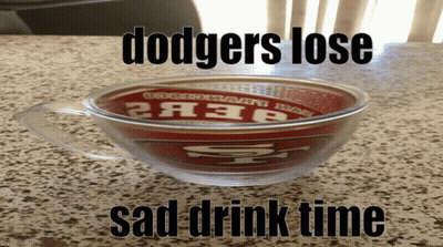 A Cup With The Word Dodgers On It Sits On A Counter GIF