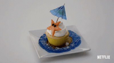 A Cupcake With A Starfish And An Umbrella On Top Of It On A White Plate With Netflix Written On The Bottom GIF