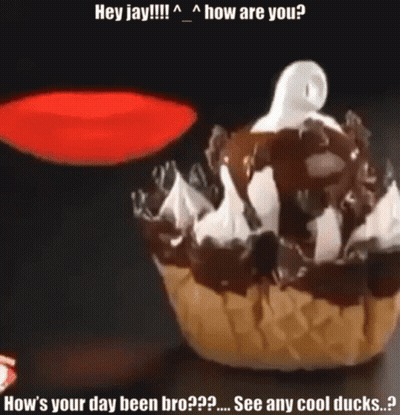 A Cupcake With Chocolate Sauce And Whipped Cream Has A Ghost On Top Of It GIF