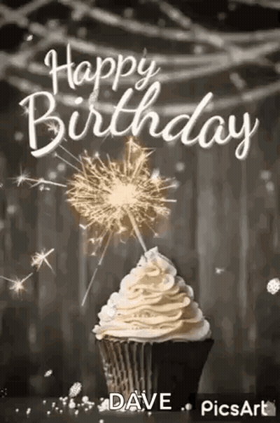 A Cupcake With Whipped Cream And A Sparkler On Top . GIF