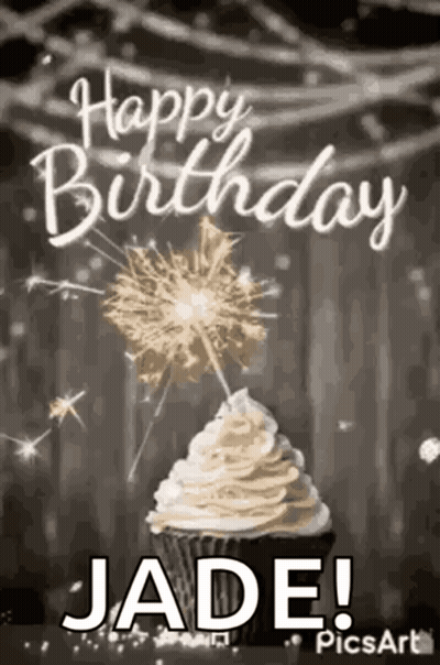 A Cupcake With Whipped Cream And Sparklers On Top Of It . GIF