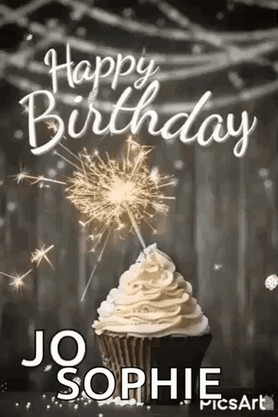 A Cupcake With Whipped Cream And Sparklers On Top Of It . GIF