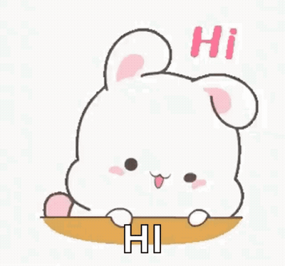 A Cute Cartoon Rabbit Is Sitting On A Table And Saying Hi . GIF