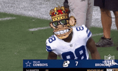 A Dallas Cowboys Football Player Wearing A Monkey Mask Stands On The Field GIF
