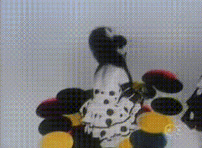 A Dalmatian Is Standing In Front Of A Bunch Of Colorful Balls GIF