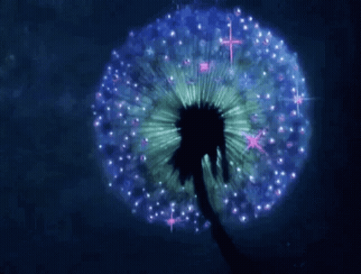 A Dandelion With Purple And Green Petals Is Glowing In The Dark . GIF