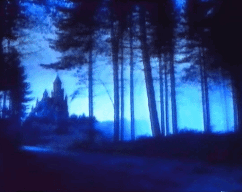 A Dark Blue Forest With A Castle In The Distance GIF