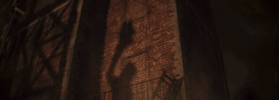 A Dark Brick Wall With A Fire Escape In Front Of It GIF