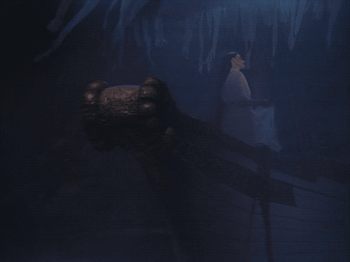 A Dark Cave With Ice Formations And A Hand Reaching Out GIF