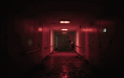 A Dark Hallway With Red Lights And A Door That Says 1 On It GIF