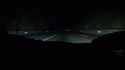 A Dark Highway With A White Line On The Right GIF