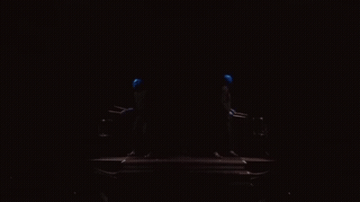 A Dark Room With A Blue Light Coming Out Of The Corner GIF