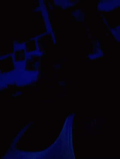 A Dark Room With A Blue Light Shining On The Wall GIF
