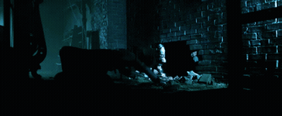A Dark Room With A Brick Wall And A Hole In The Floor GIF
