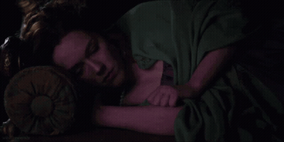 A Dark Room With A Chandelier Hanging From The Ceiling And A Piano GIF