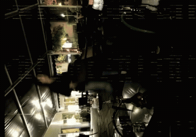 A Dark Room With A Few Lights On And A Few People GIF