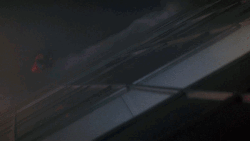 A Dark Room With A Few Spots Of Light On The Wall GIF