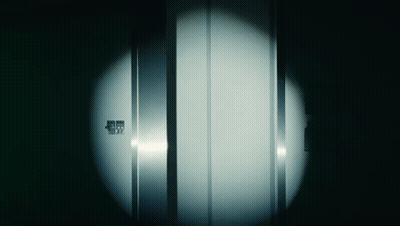 A Dark Room With A Light Shining On A Door That Says ' Emergency Exit ' On It GIF