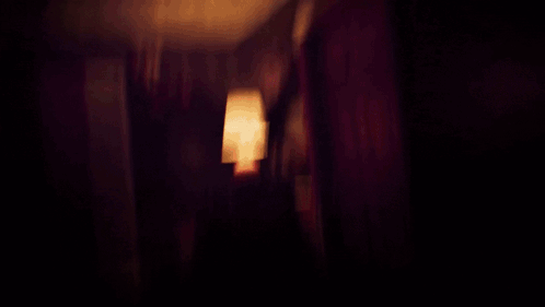 A Dark Room With A Red Light On The Ceiling GIF