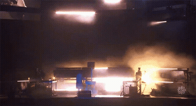 A Dark Room With Smoke Coming Out Of It And A Few Lights GIF