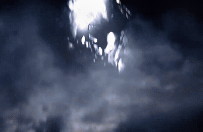 A Dark Sky With A Few Clouds And A Building In The Distance GIF