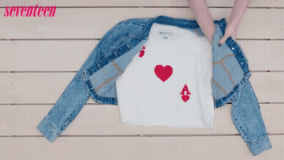 A Denim Jacket And Jeans Are On A Wooden Table With The Words Seventeen In Pink GIF