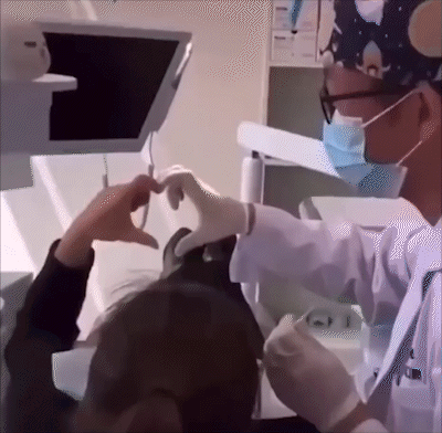 A Dentist Is Making A Heart With His Hands GIF