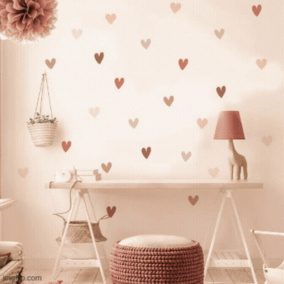 A Desk With Hearts On The Wall And A Lamp GIF