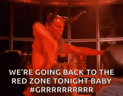 A Devil Is Dancing On A Stage In A Dark Room With A Woman . GIF