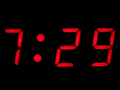 A Digital Clock Displays The Time As 7:30 On A Black Background GIF