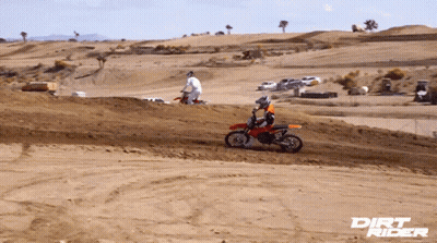 A Dirt Rider Poster Shows A Man Riding A Dirt Bike On A Dirt Track GIF