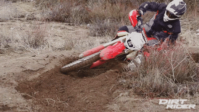 A Dirt Rider Riding A Red Dirt Bike In The Dirt GIF