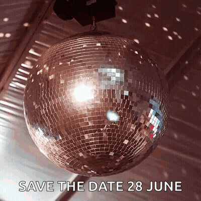 A Disco Ball Is Hanging From The Ceiling With The Words Save The Date 28 June Below It GIF
