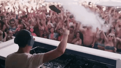 A Dj Is Playing Music In Front Of A Crowd Of People At A Beach Party . GIF