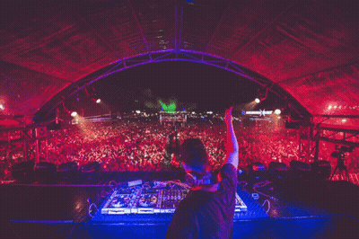 A Dj Playing Music In Front Of A Crowd With A Sign That Says ' X ' On It GIF