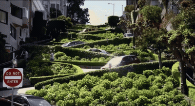 A Do Not Enter Sign Is On The Side Of A Very Narrow Street GIF
