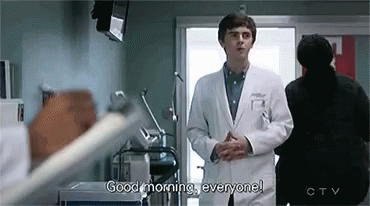 A Doctor Is Standing In A Hospital Room Talking To A Patient . GIF