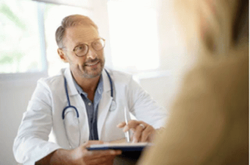 A Doctor Is Talking To A Patient In A Hospital Room While Holding A Tablet . GIF