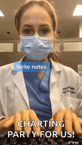 A Doctor Wearing A Face Mask Is Typing On A Keyboard . GIF