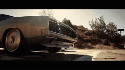 A Dodge Charger Is Parked On A Road GIF