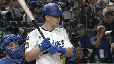 A Dodgers Baseball Player Holds A Bat In His Hands GIF