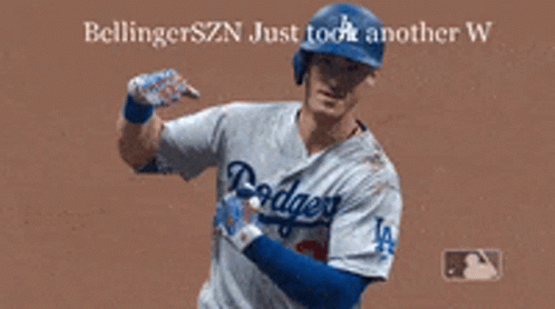 A Dodgers Baseball Player Is Flexing His Muscles On The Field GIF