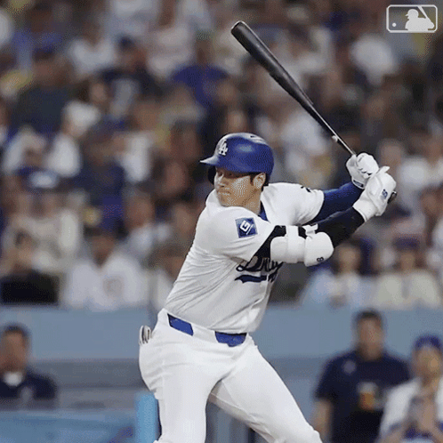A Dodgers Baseball Player Is Swinging At A Pitch GIF