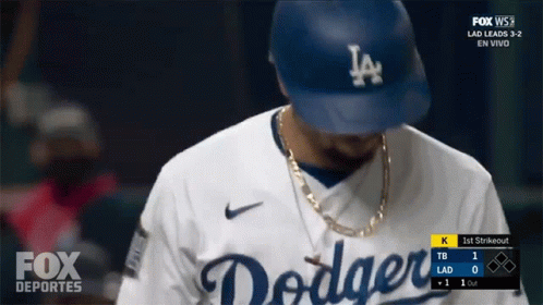 A Dodgers Baseball Player Wearing A Hat And A Necklace GIF