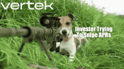 A Dog Is Holding A Sniper Rifle In The Grass GIF